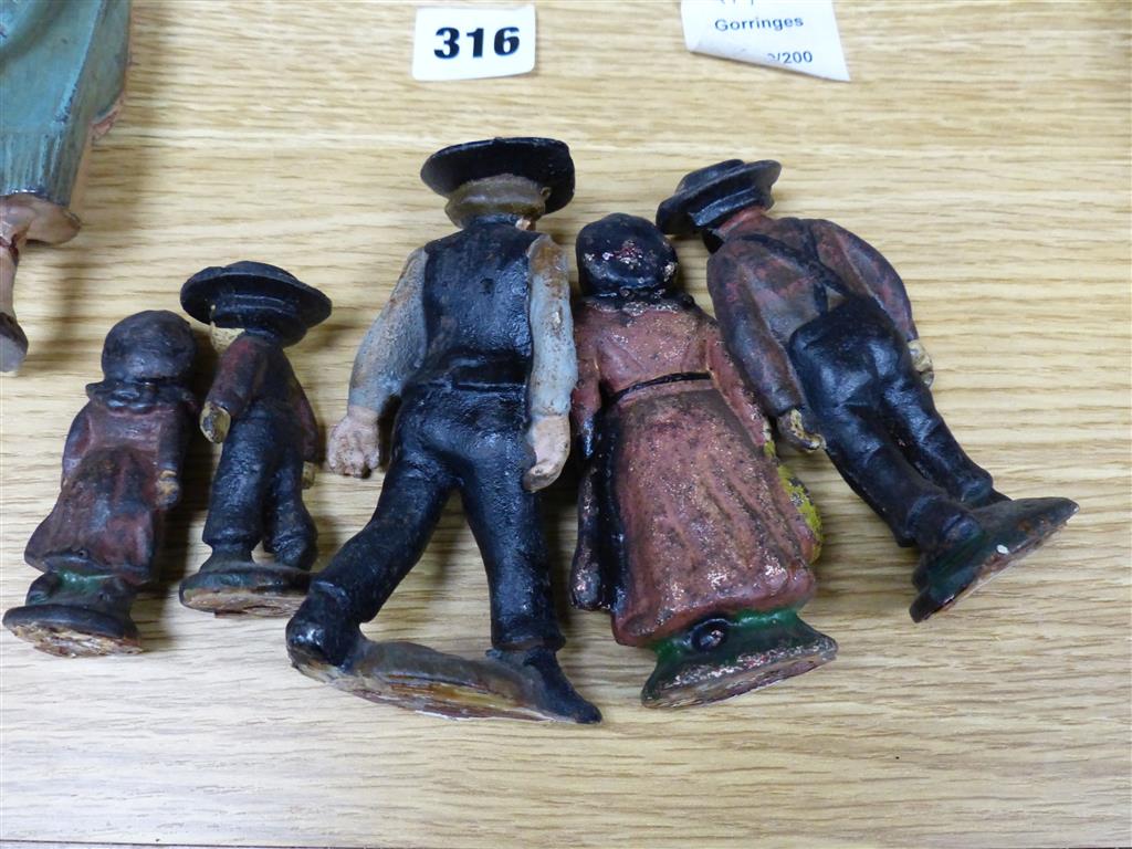 A group of American? painted cast iron and metal Amish figures, sheep money box etc.